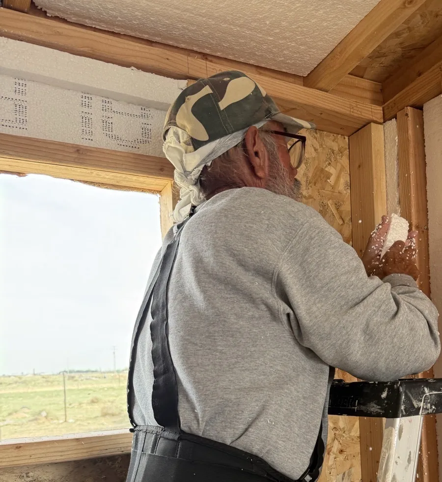 Volunteer installing insulation