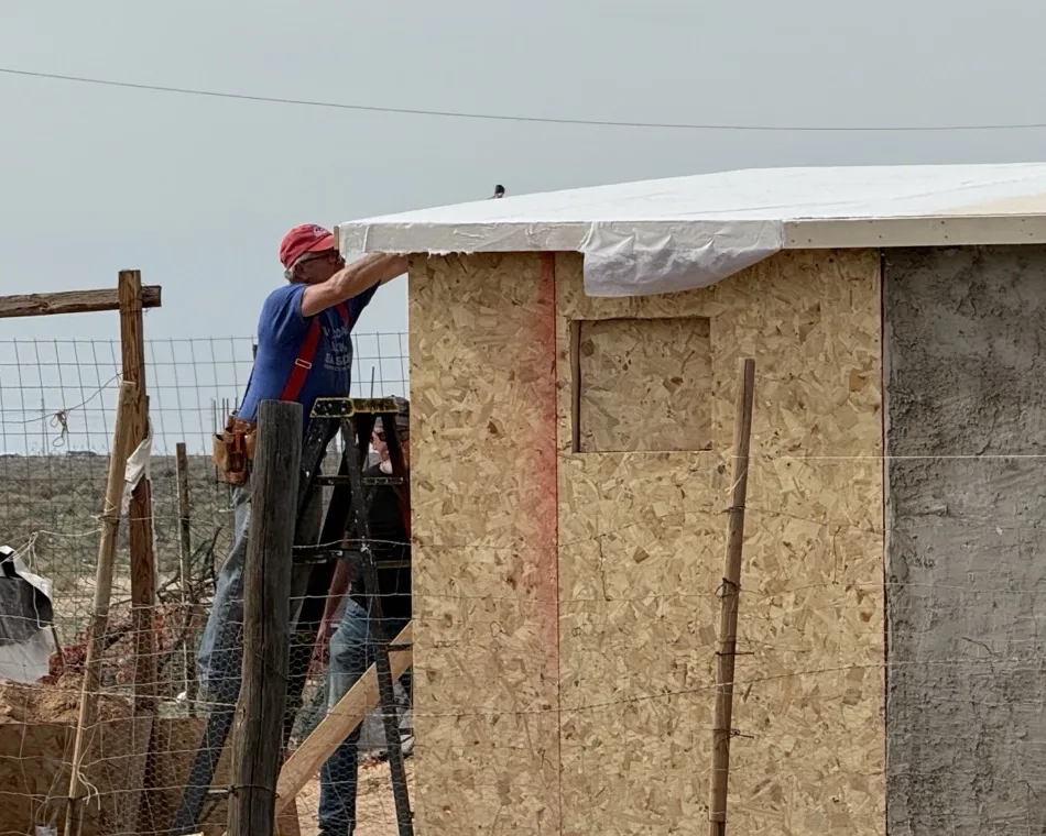 Volunteers roofing a home